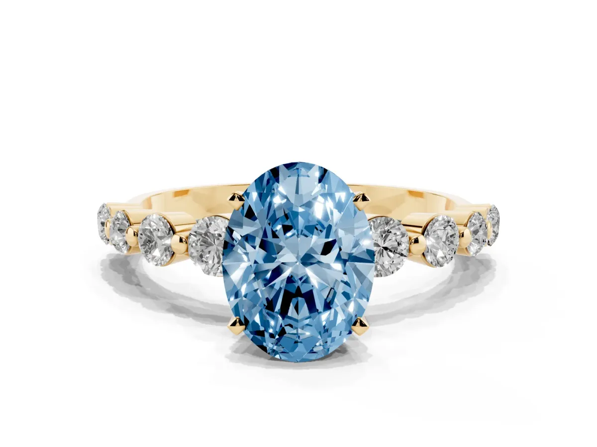 Fancy Blue Oval Cut Solitaire Diamond Ring with Pave Band and Four-Prong Setting Yellow gold
