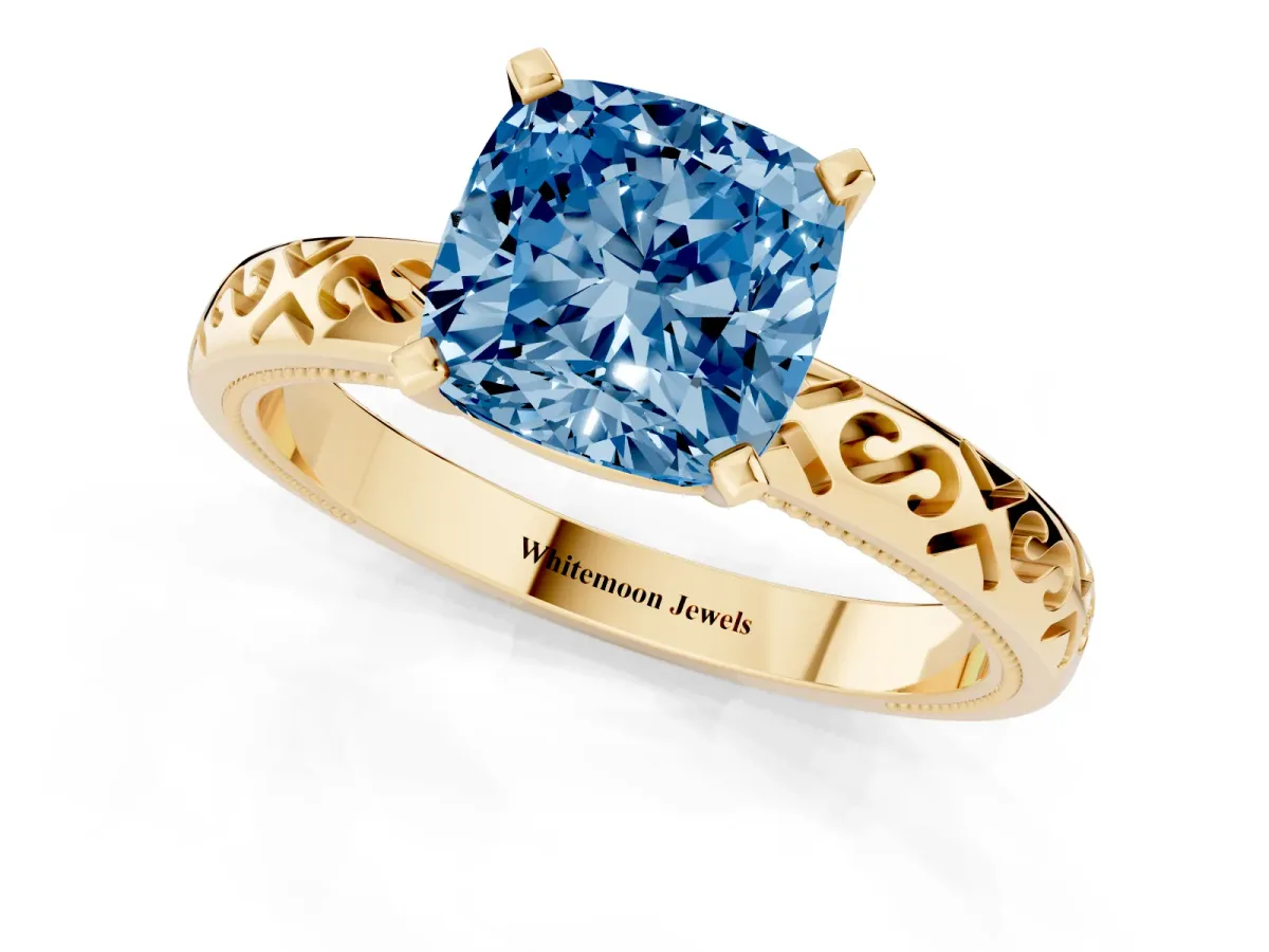 Fancy Blue Cushion Cut Solitaire Engagement Ring with Scrollwork Band and Four-Prong Setting Yellow gold
