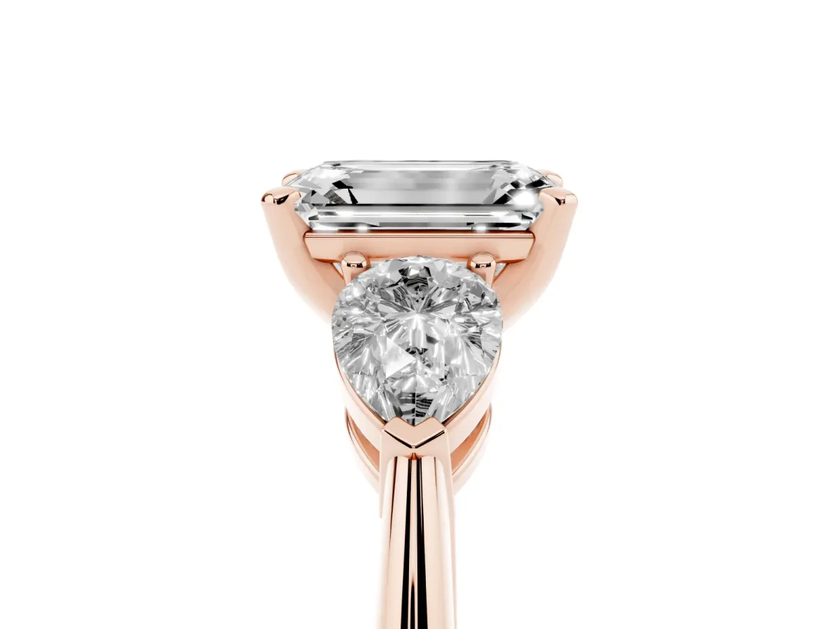 Three-Stone Emerald Cut Diamond Ring with Pear Side Stones and Four-Prong Setting Rose gold