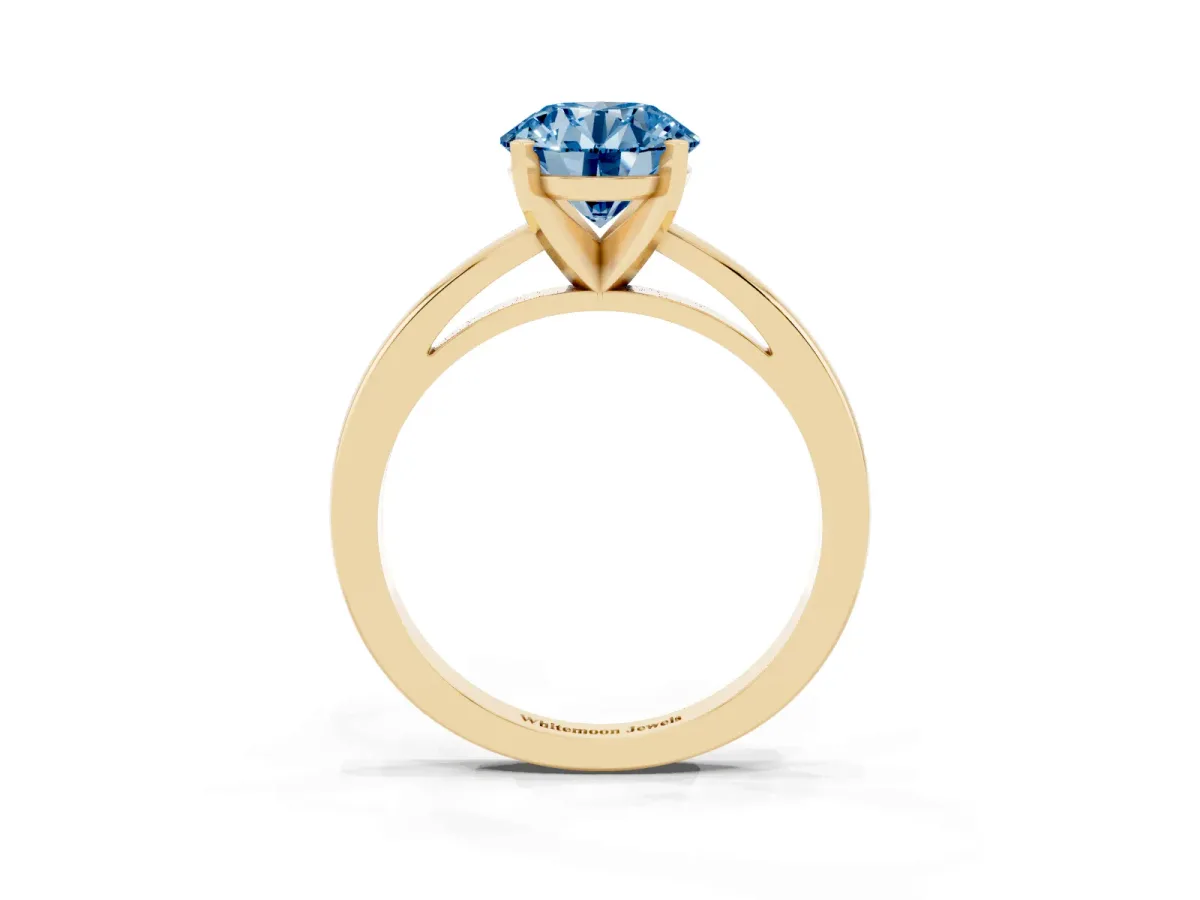 Fancy Blue Round Cut Solitaire Diamond Engagement Ring with Four-Prong Setting on a Classic Band Yellow gold