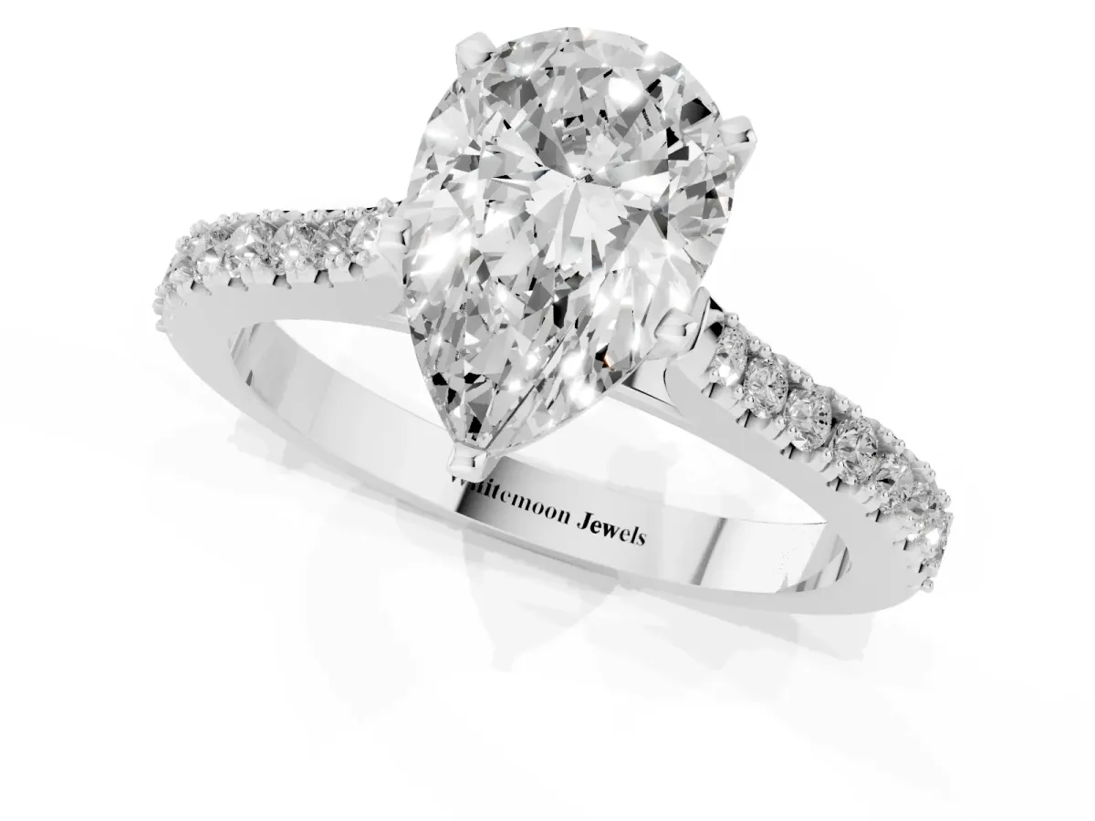 Pear Cut Cut Solitaire Diamond Engagement Ring with Pave Band and Four-Prong Setting Platinum