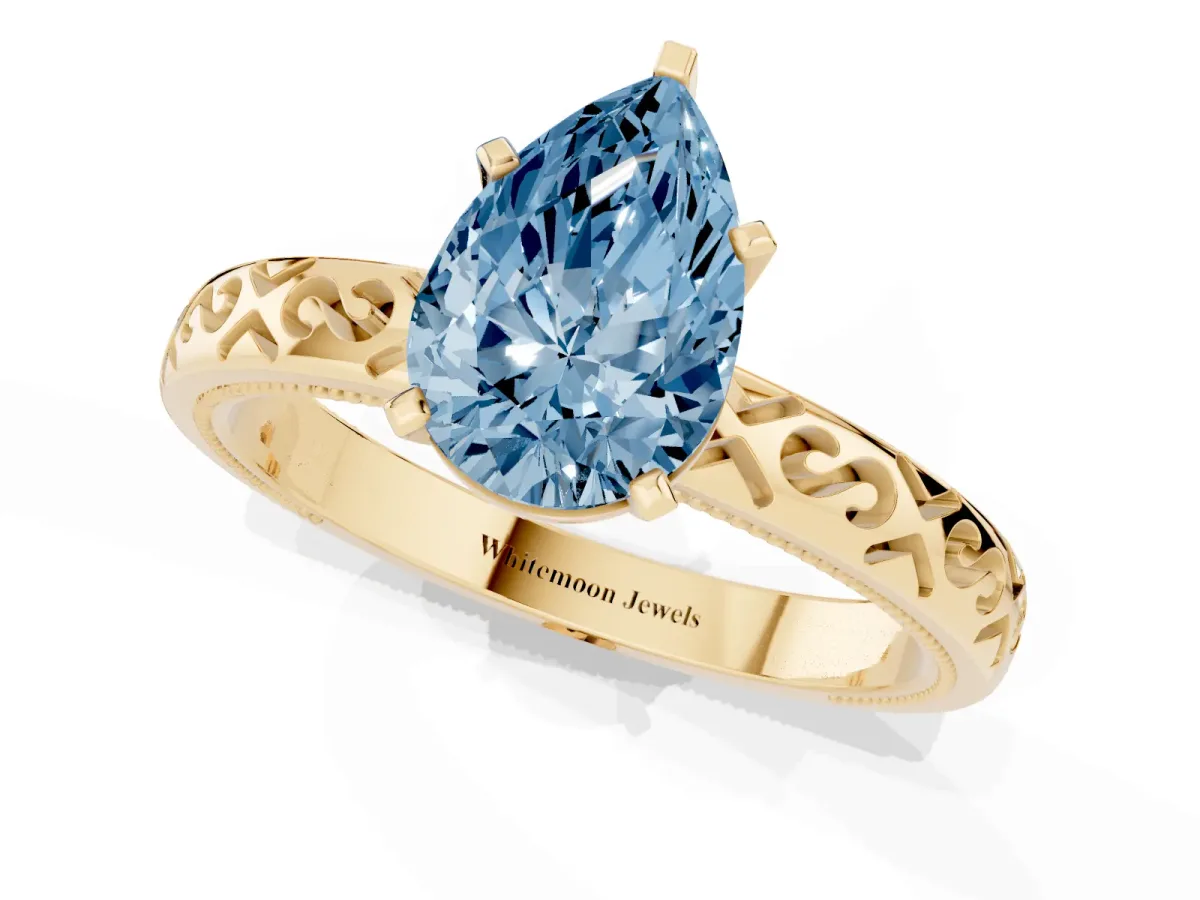 Fancy Blue Pear Cut Solitaire Engagement Ring with Scrollwork Band and Four-Prong Setting Yellow gold