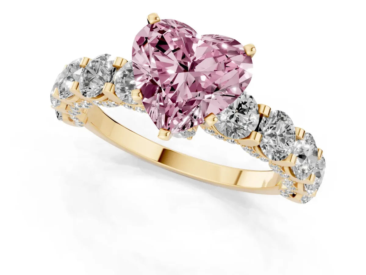 Fancy Pink Heart Cut Diamond Side Stone Engagement Ring with Four-Prong Setting Yellow gold