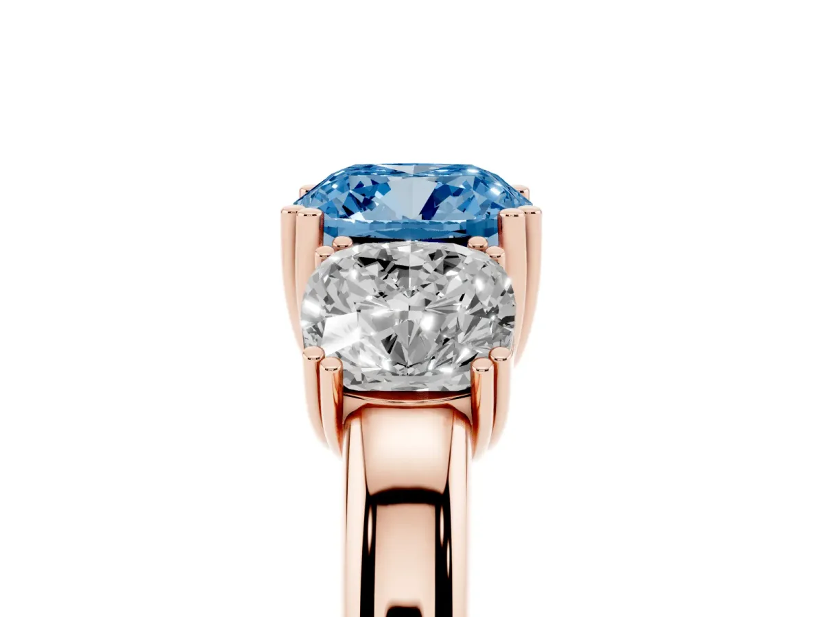 Fancy Blue Three-Stone Cushion Cut Cut Diamond Ring with Channel Set Band and Four-Prong Setting Rose gold