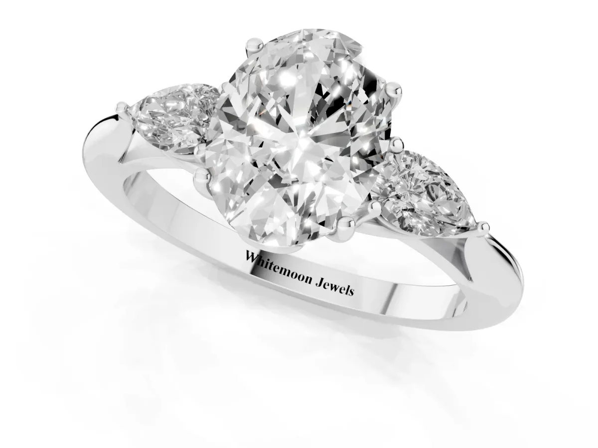 Three-Stone Oval Cut Diamond Ring with Pear Side Stones in Four-Prong Setting Platinum