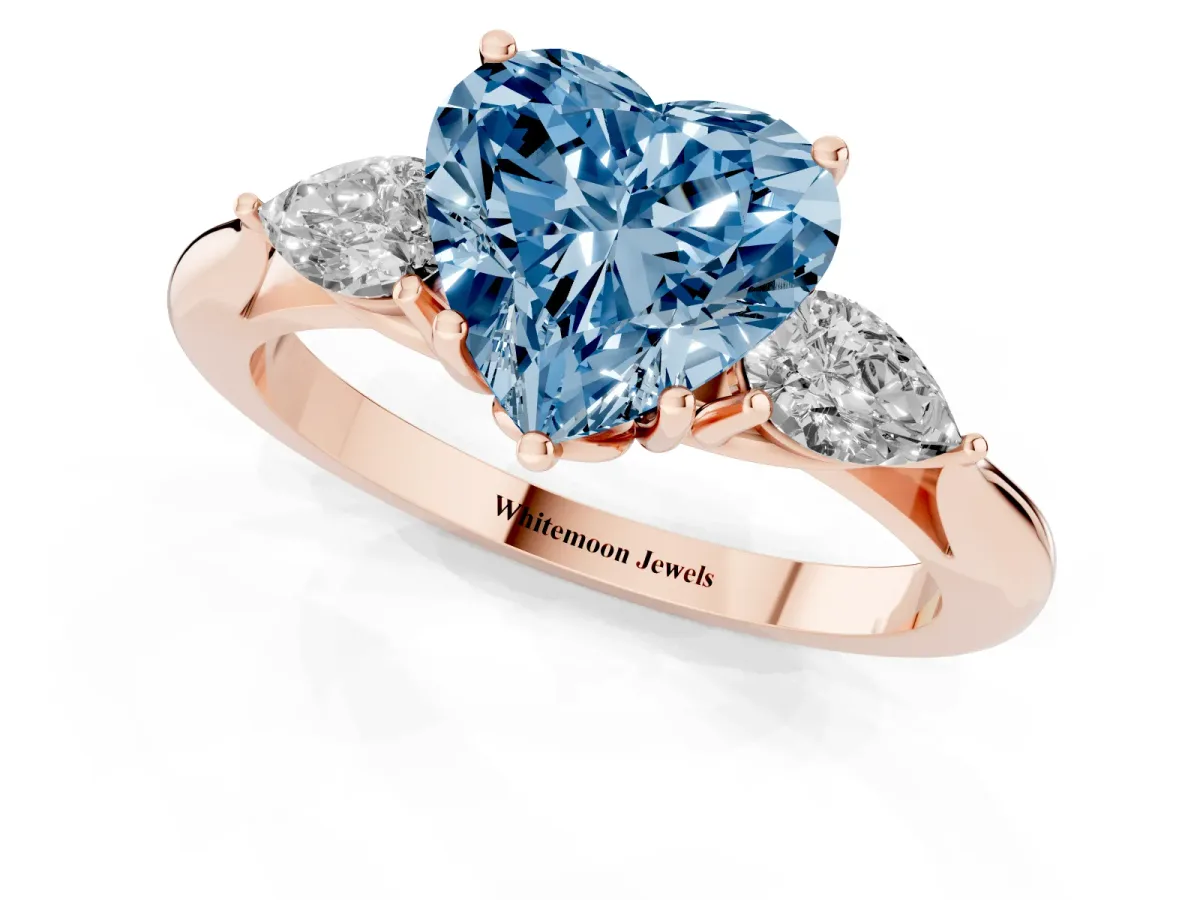 Fancy Blue Three-Stone Heart Cut Diamond Ring with Pear Side Stones in Four-Prong Setting Rose gold