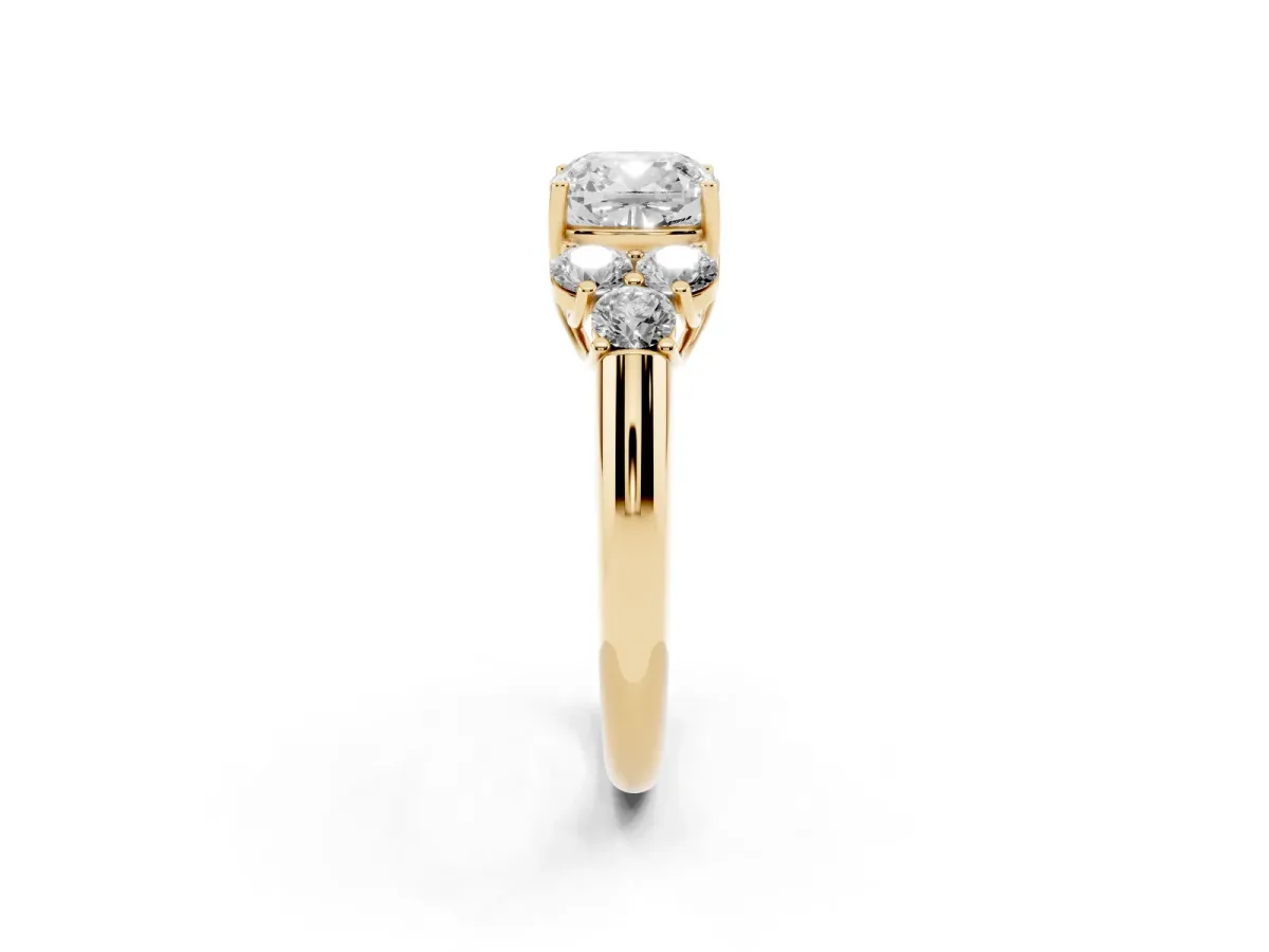 Cushion Cut Cut Diamond Cluster Ring with Round Accent Stones and Prong Setting on a Classic Band Yellow gold