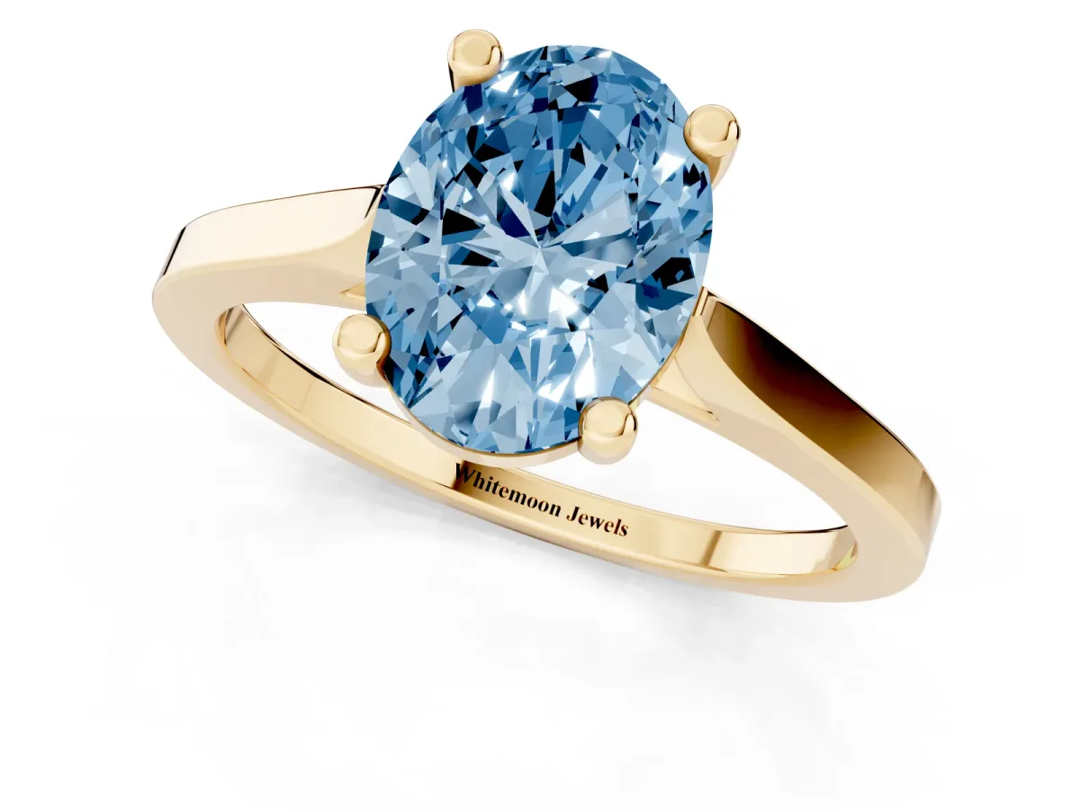 Fancy Blue Oval Cut Solitaire Diamond Ring with Four-Prong Setting and Tapered Band Yellow gold