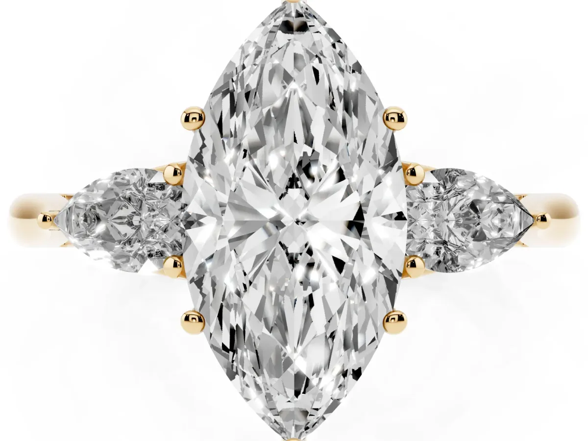 Three-Stone Marquise Cut Diamond Ring with Pear Side Stones in Four-Prong Setting Yellow gold