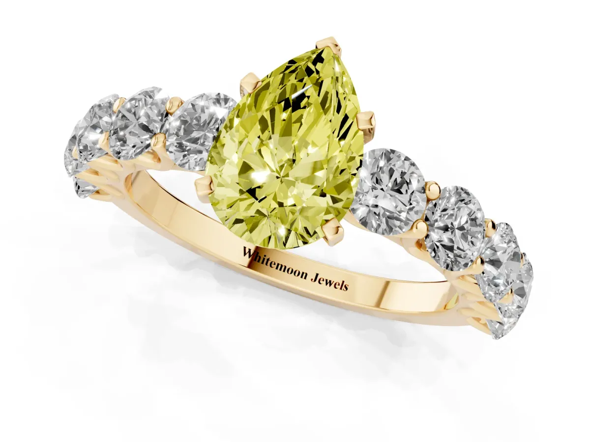Fancy Yellow Pear Cut Diamond Prong Setting with Side Stones on a Pave Band Yellow gold