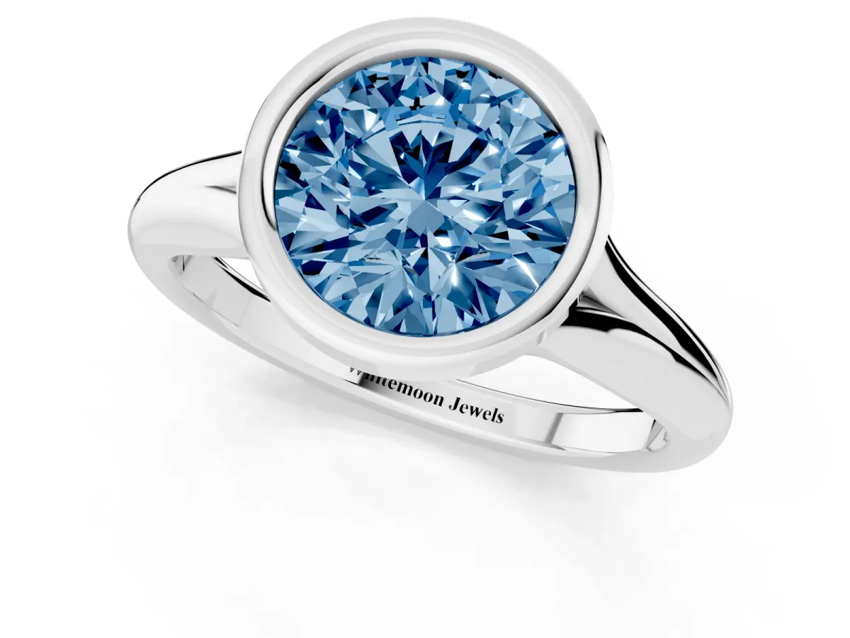 Fancy Blue Bezel Set Round Cut Solitaire Diamond Ring with Smooth Band Silver