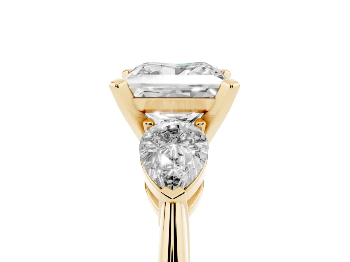 Three-Stone Princess Cut Diamond Ring with Pear Side Stones and Four-Prong Setting Yellow gold