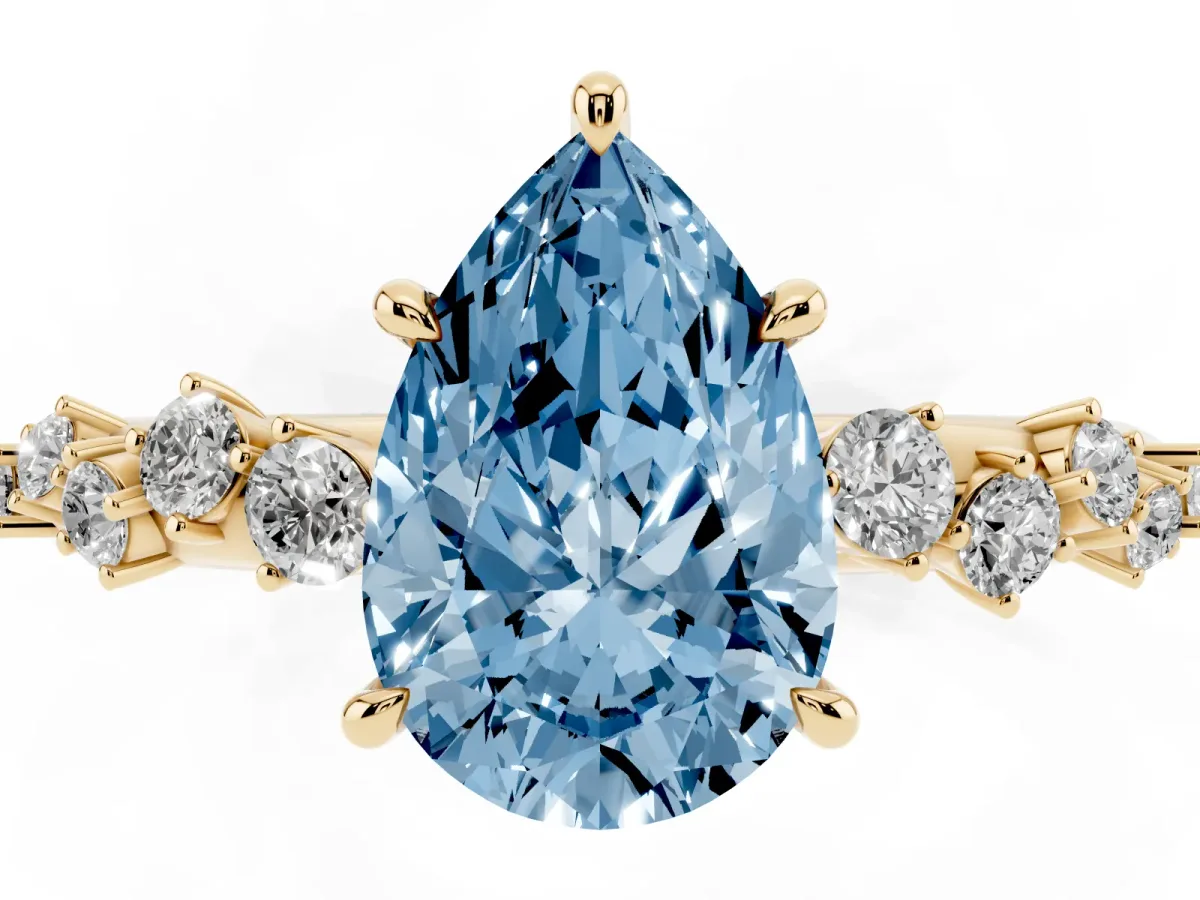 Fancy Blue Pear Cut Diamond Cluster Side Stone Solitaire Ring with Prong Setting Yellow gold
