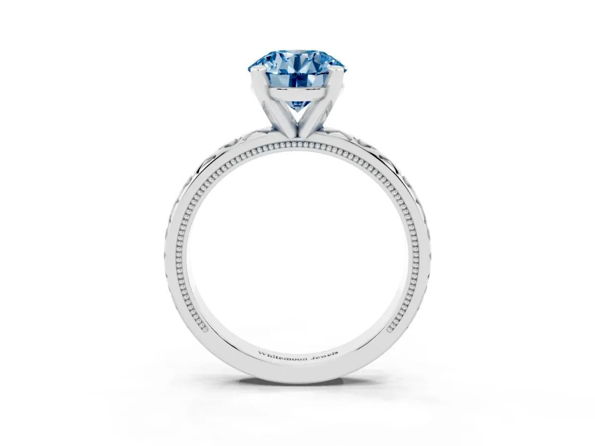 Fancy Blue Round Cut Solitaire Diamond Engagement Ring with XO Engraved Band and Four-Prong Setting Silver