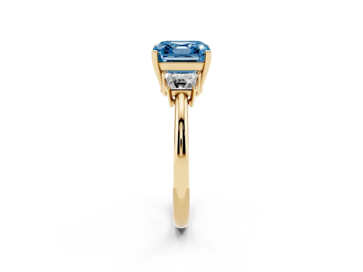 Fancy Blue Asscher Cut Diamond Three-Stone Ring with Trapezoid Side Stones and Prong Setting Yellow gold