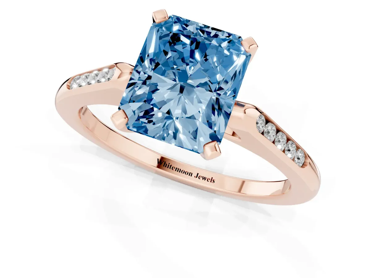 Fancy Blue Radiant Cut Diamond Solitaire Ring with Channel Set Round Band and Prong Setting Rose gold