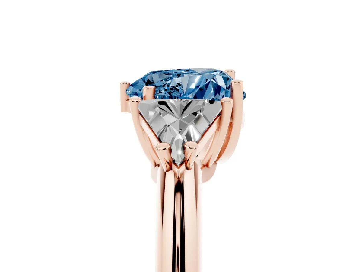 Fancy Blue Three-Stone Heart Cut Diamond Engagement Ring with Trillion Side Stones and Prong Setting Rose gold