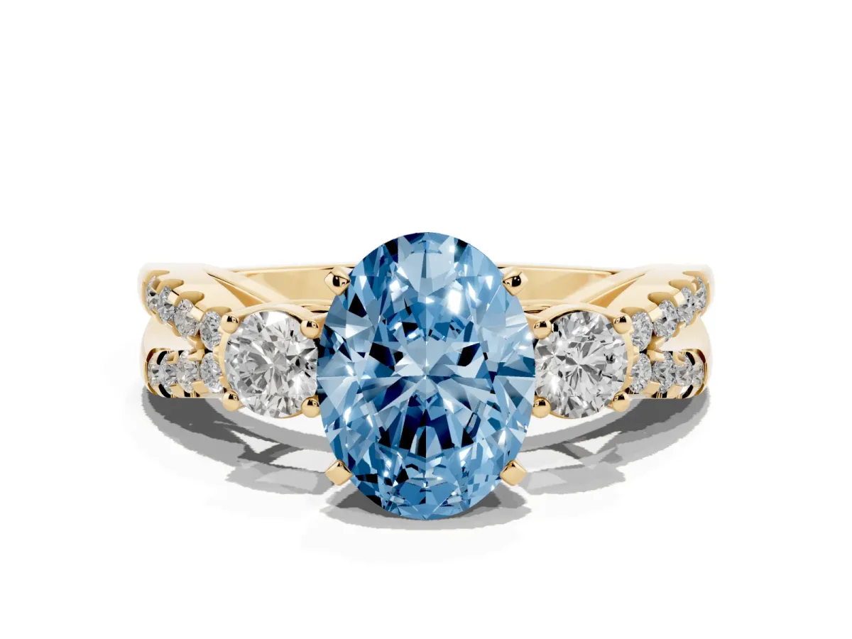 Fancy Blue Oval Cut Diamond Three-Stone Ring with Pavé Split Shank and Four-Prong Setting Yellow gold