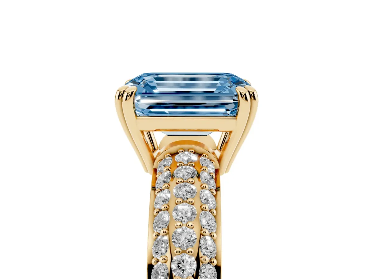 Fancy Blue Emerald Cut Diamond Solitaire Ring with Multi-Row Round Pavé Band and Prong Setting Yellow gold
