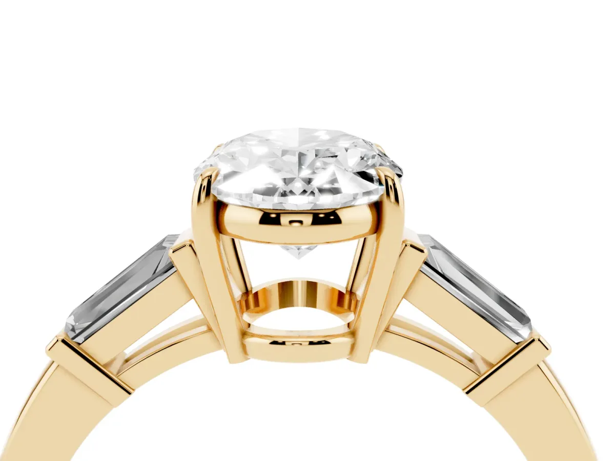 Oval Cut Diamond Three-Stone Ring with Tapered Baguette Side Stones and Prong Setting Yellow gold