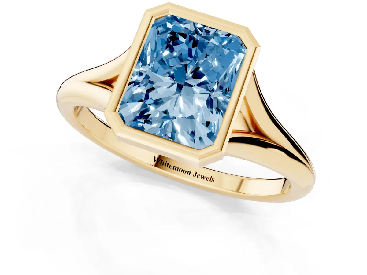 Fancy Blue Bezel Set Radiant Cut Cut Solitaire Ring with Tapered Band Yellow gold