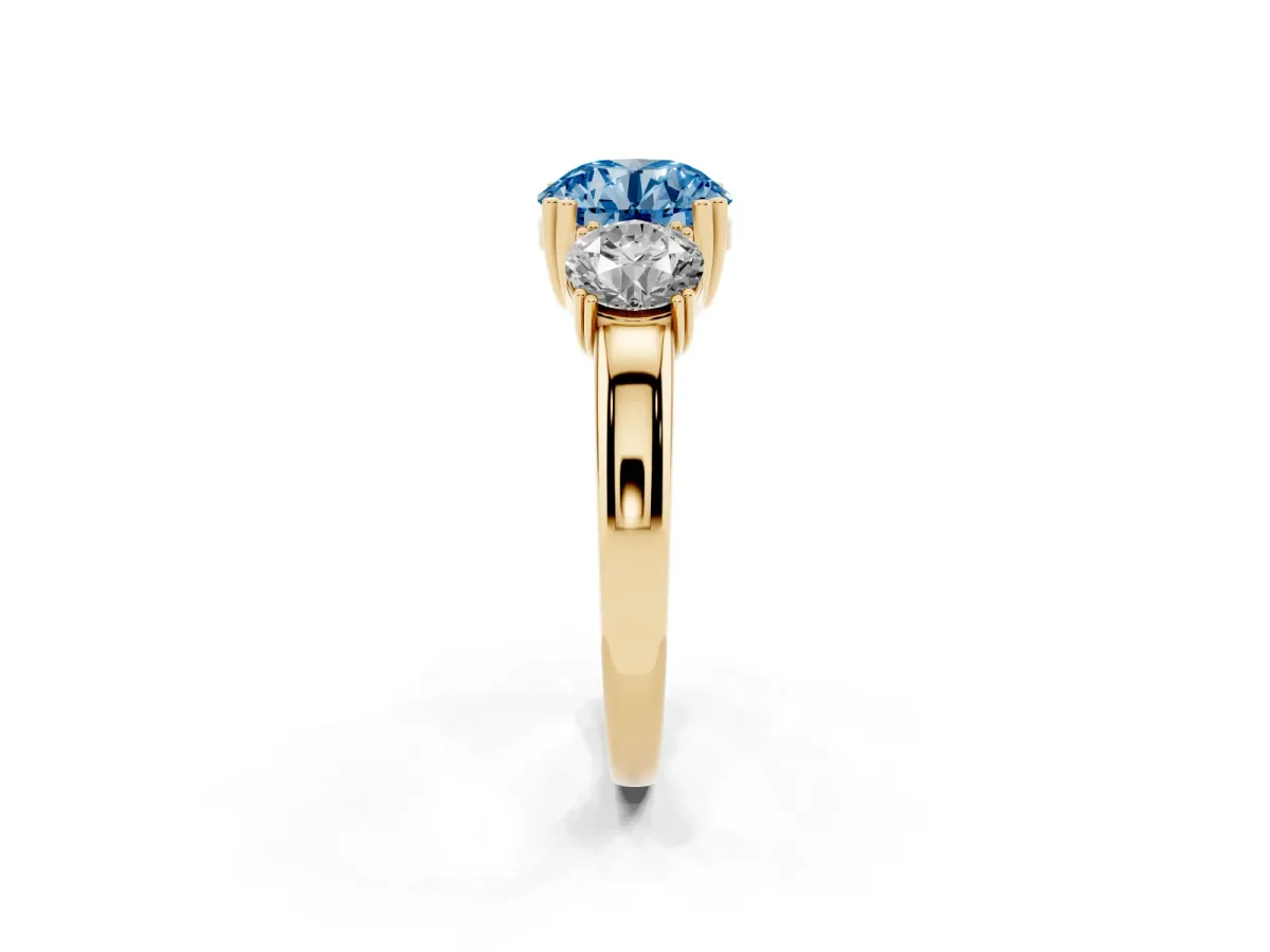 Fancy Blue Three-Stone Round Cut Cut Diamond Ring with Channel Set Band and Four-Prong Setting Yellow gold