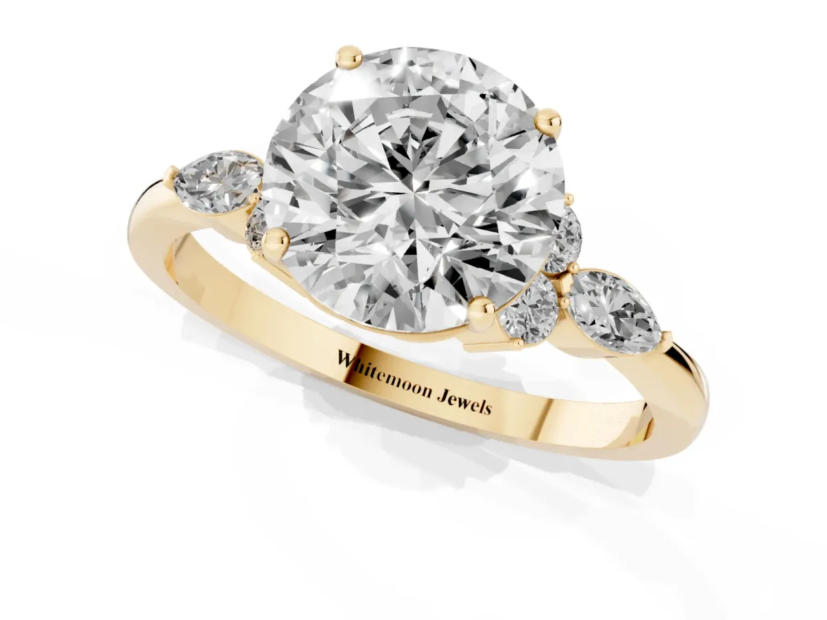 Round Cut Brilliant Diamond Solitaire Ring with Pear Side Stones and Four-Prong Setting Yellow gold