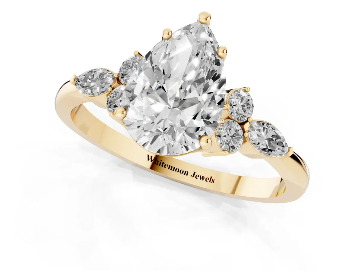 Pear Cut Brilliant Diamond Solitaire Ring with Pear Side Stones and Four-Prong Setting Yellow gold