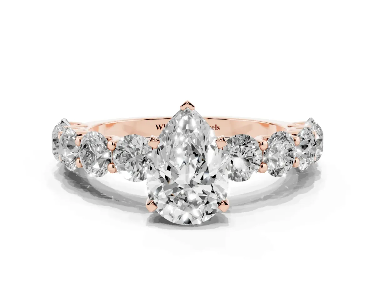Pear Cut Diamond Prong Setting with Side Stones on a Pave Band Rose gold