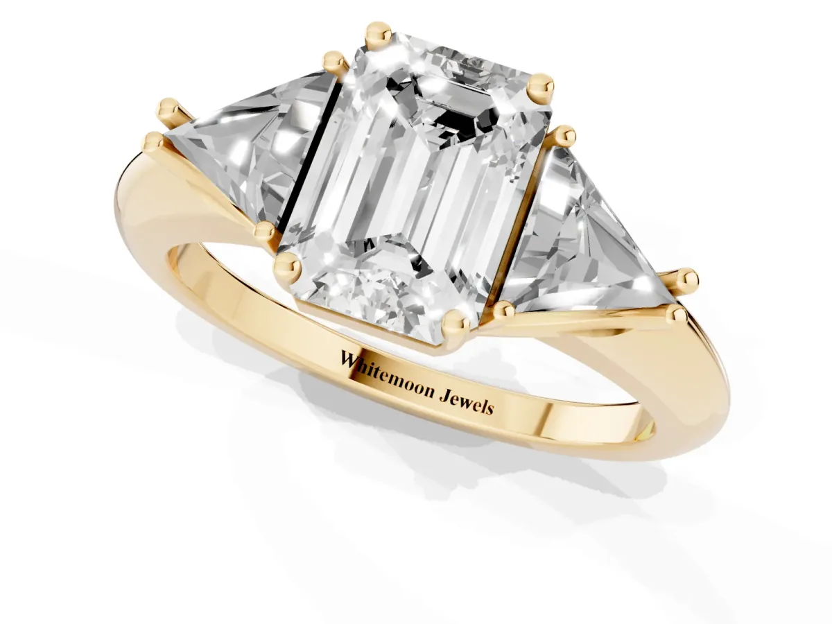Three-Stone Emerald Cut Diamond Engagement Ring with Trillion Side Stones and Prong Setting Yellow gold