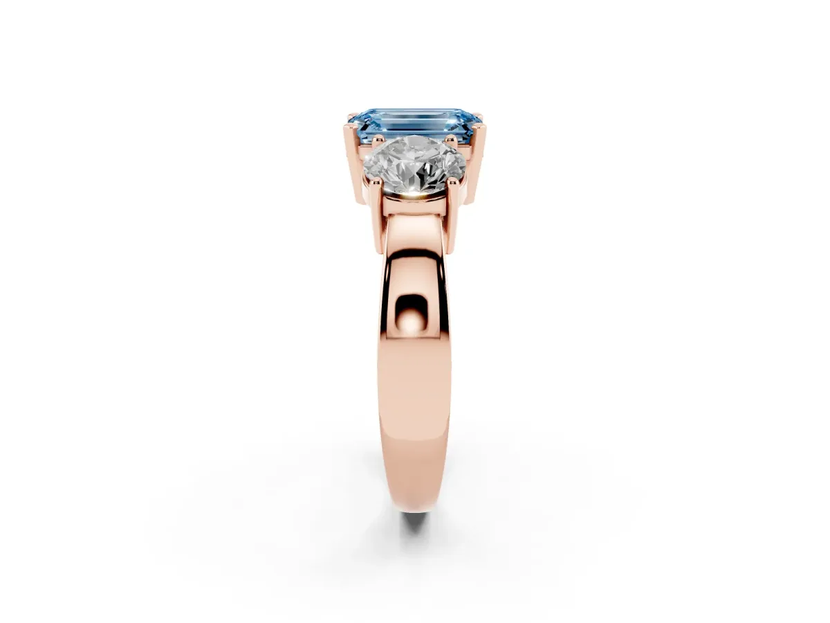 Fancy Blue Three-Stone Emerald Cut Diamond Ring with Round Side Stones, Classic Band, and Four-Prong Setting Rose gold