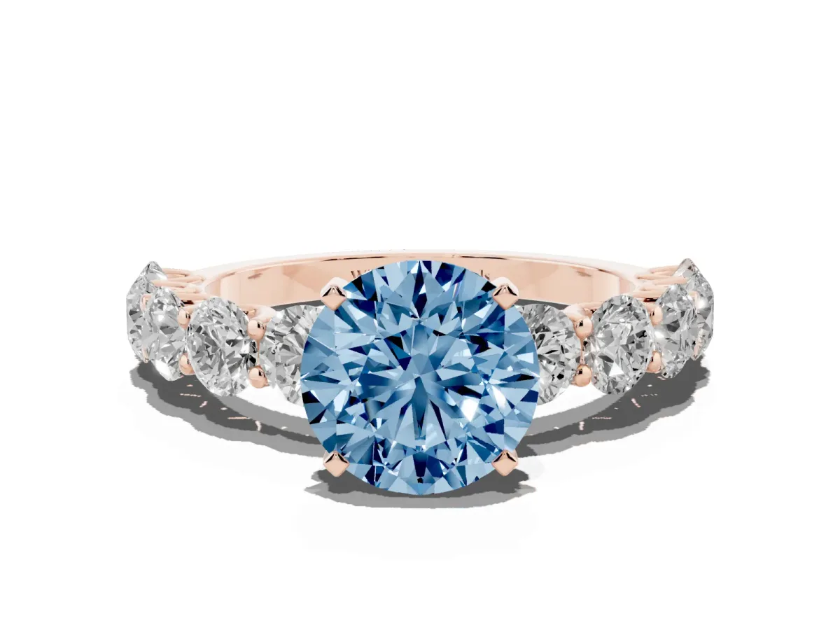 Fancy Blue Round Cut Diamond Prong Setting with Side Stones on a Pave Band Rose gold