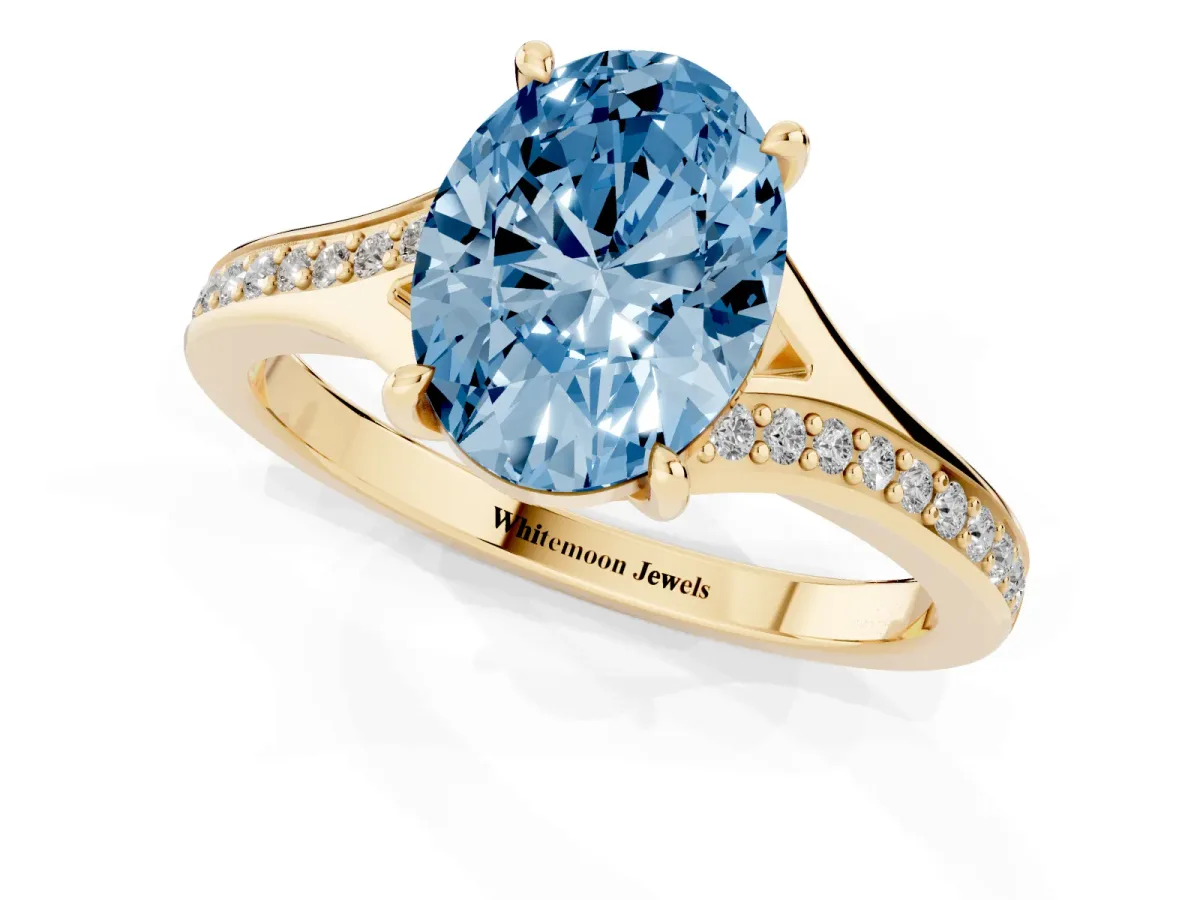 Fancy Blue Oval Cut Diamond Solitaire Ring with Pavé Band and Prong Setting Yellow gold
