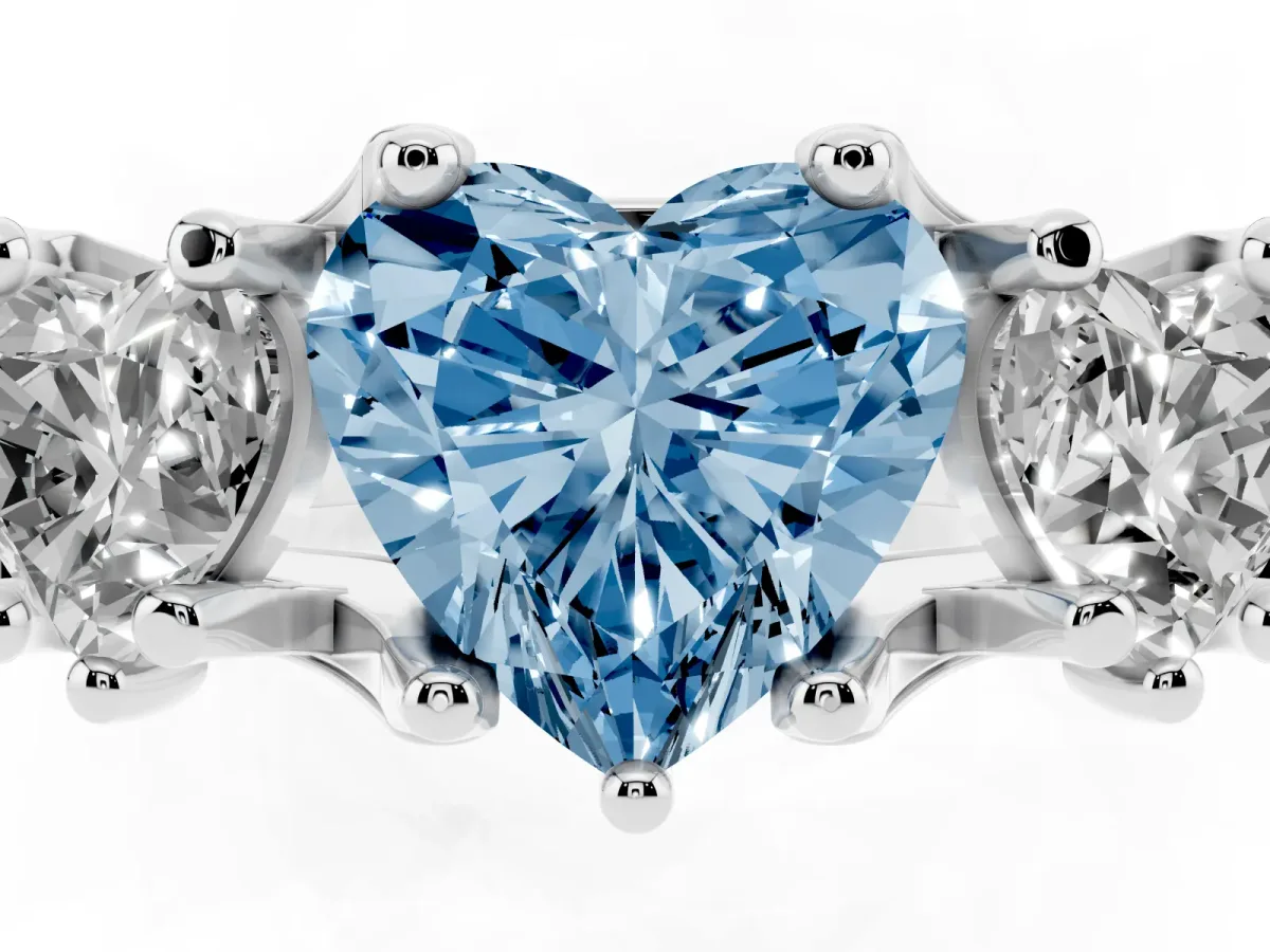 Fancy Blue Heart Cut Diamond Three-Stone Ring with Channel Set Band and Four-Prong Setting Silver