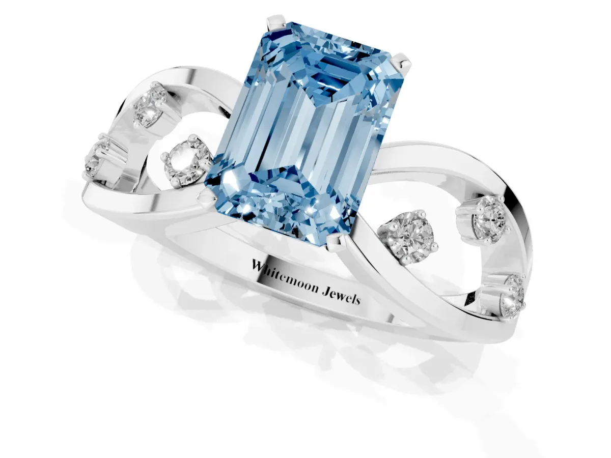 Fancy Blue Emerald Cut Cut Solitaire Diamond with Side Stones on Criss-Cross Band and Four-Prong Setting Platinum