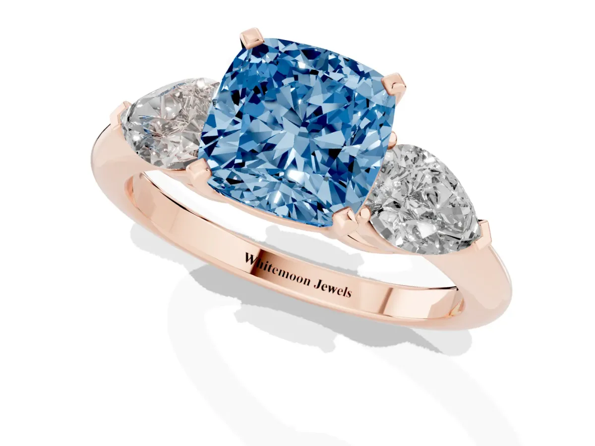 Fancy Blue Three-Stone Cushion Cut Diamond Ring with Pear Side Stones and Four-Prong Setting Rose gold