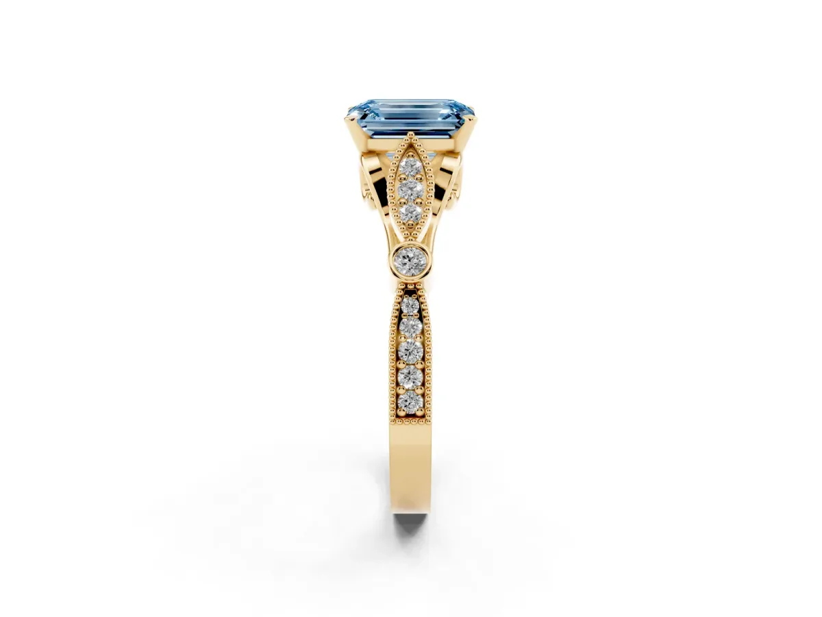 Fancy Blue Emerald Cut Cut Diamond with Milgrain Marquise and Bezel Accents on a Solitaire Band with Prong Setting Yellow gold