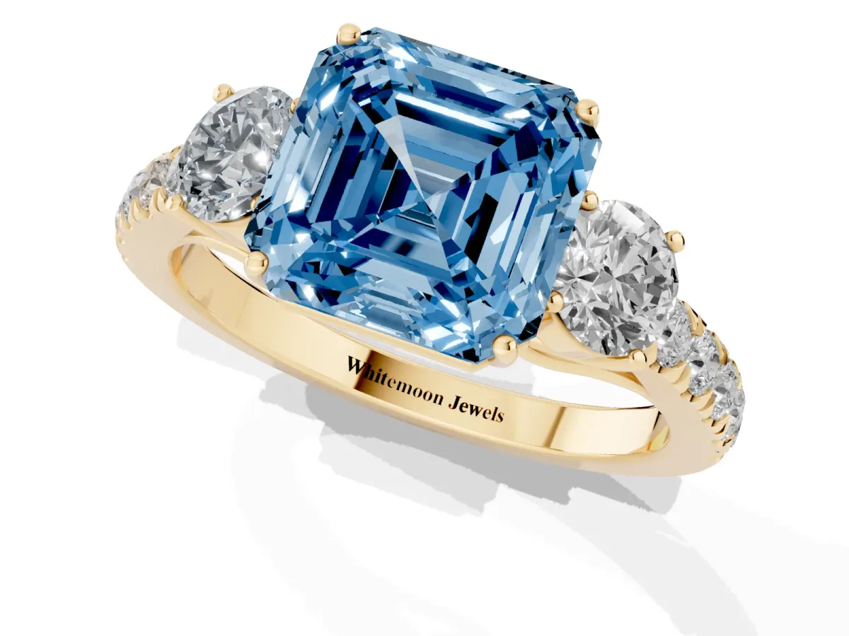 Fancy Blue Asscher Cut Cut Diamond Three-Stone Ring with Round Side Stones and Pavé Band Yellow gold