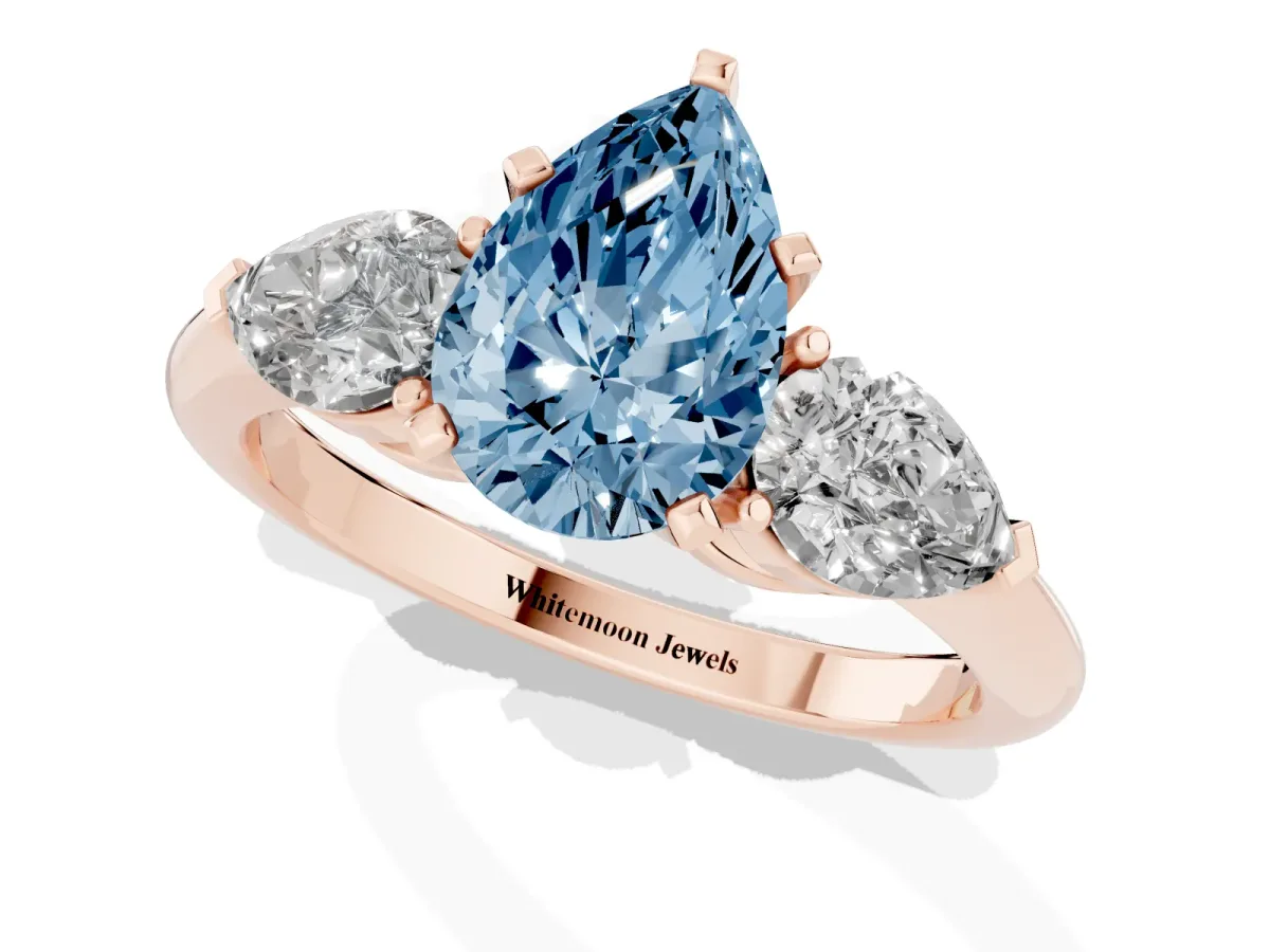 Fancy Blue Three-Stone Pear Cut Diamond Ring with Pear Side Stones and Four-Prong Setting Rose gold