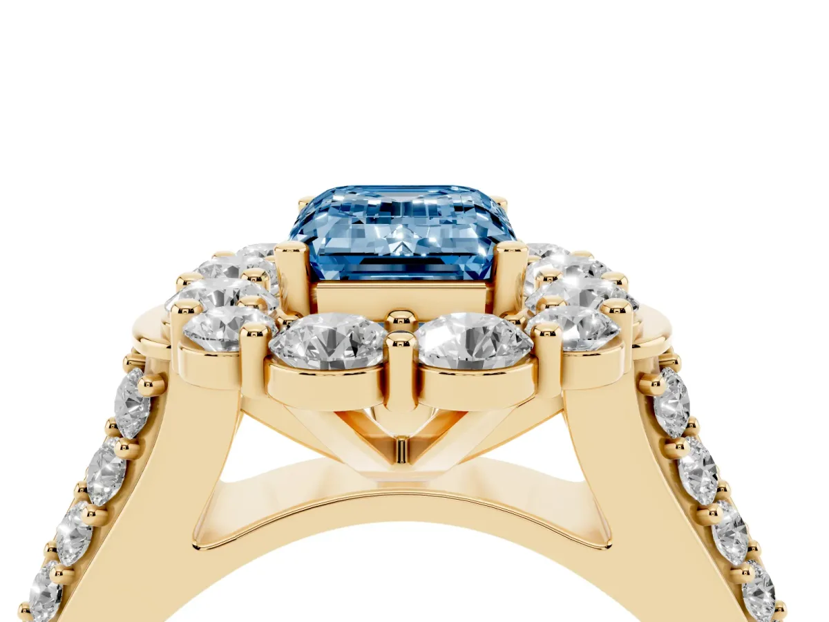 Fancy Blue Emerald Cut Halo Diamond Engagement Ring with Split Shank and Prong Setting Yellow gold
