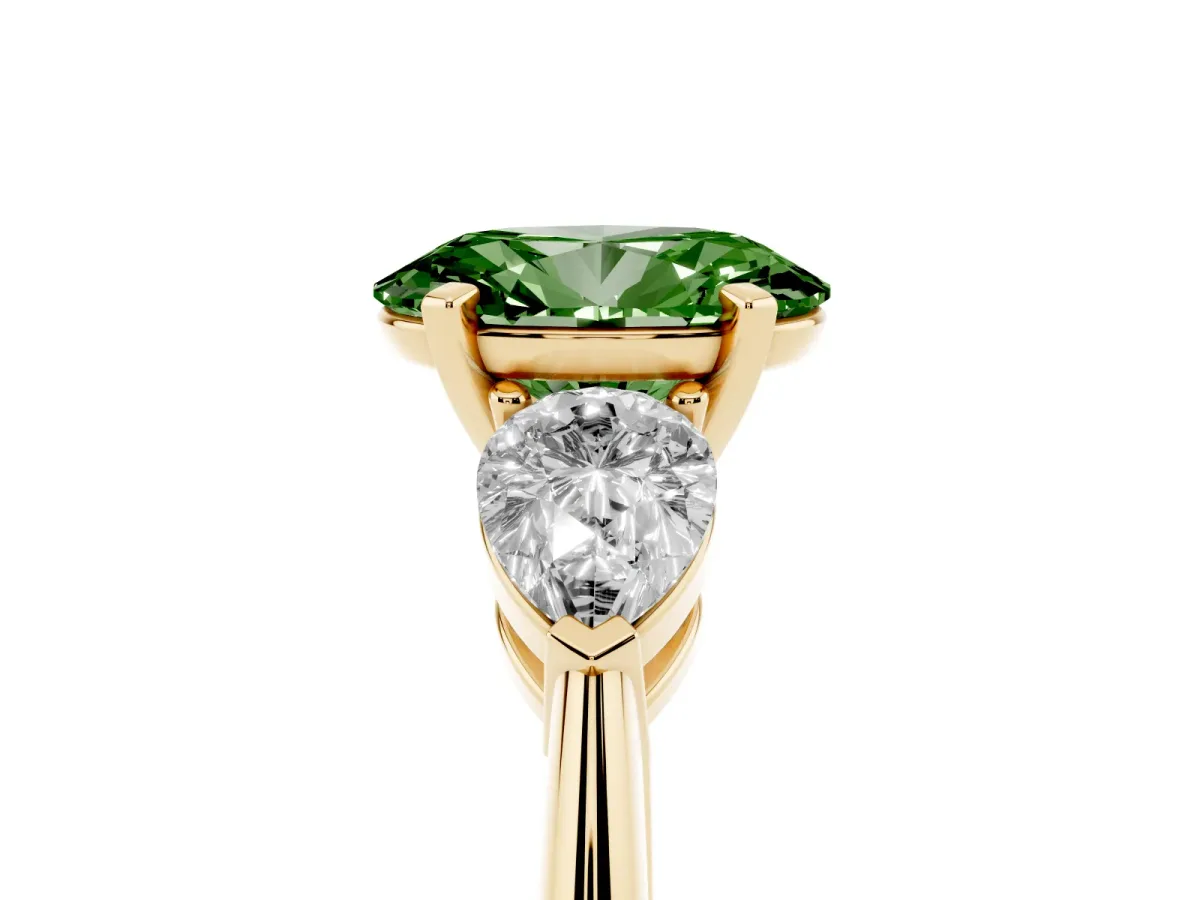 Fancy Green Three-Stone Oval Cut Diamond Ring with Pear Side Stones and Four-Prong Setting Yellow gold