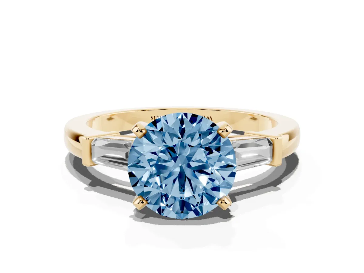 Fancy Blue Round Cut Cut Diamond Solitaire Ring with Tapered Baguette Accents and Four-Prong Setting Yellow gold