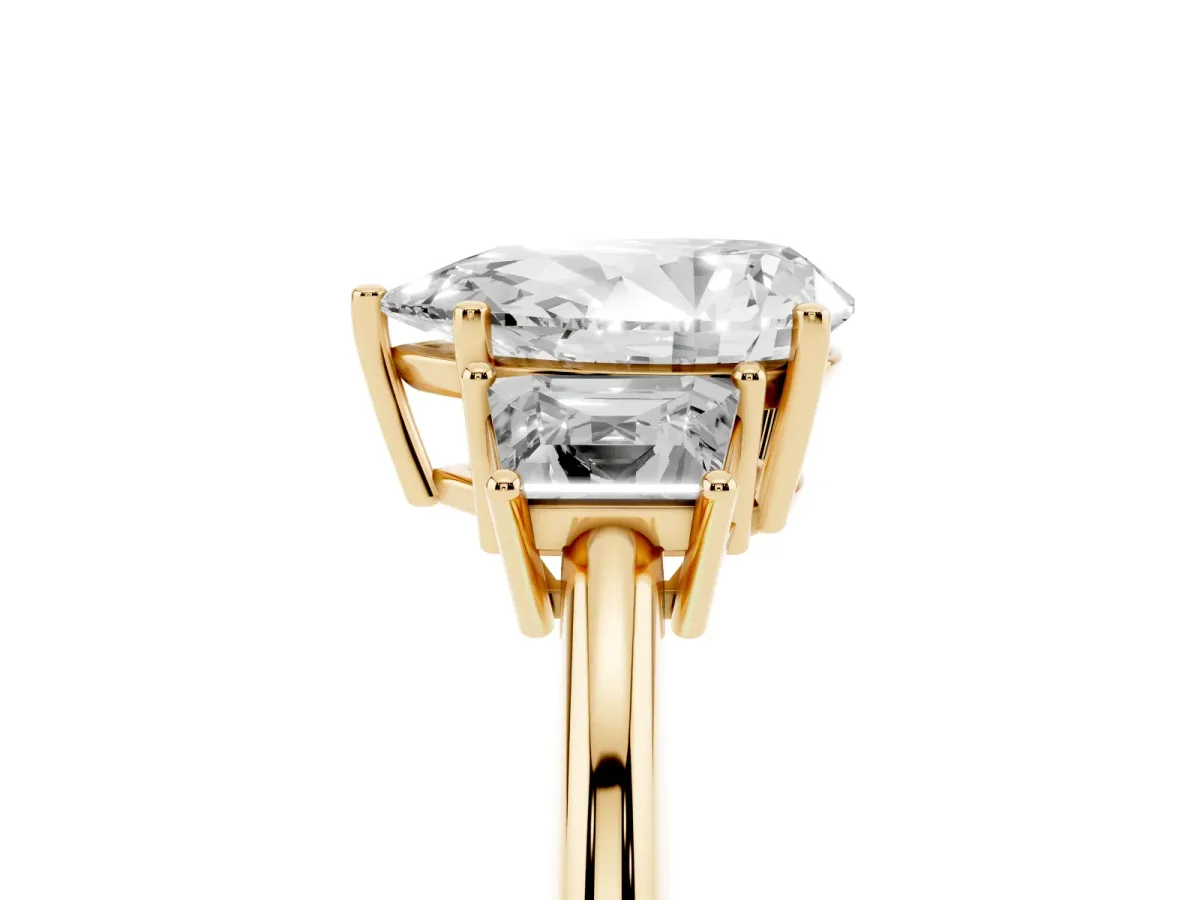 Pear Cut Diamond Three-Stone Ring with Trapezoid Side Stones and Prong Setting Yellow gold