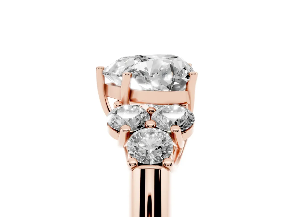 Heart Cut Cut Diamond Cluster Ring with Round Accent Stones and Prong Setting on a Classic Band Rose gold