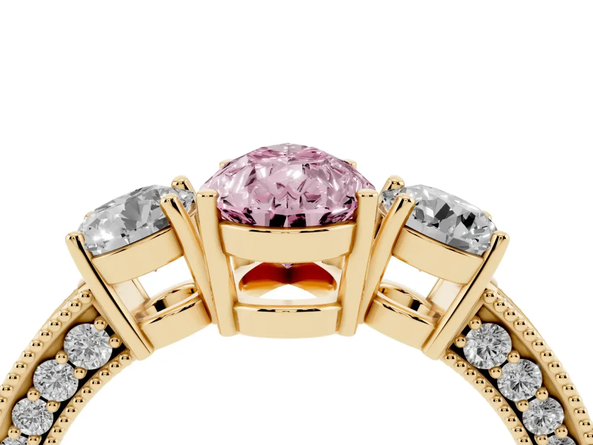 Fancy Pink Pear Cut Three-Stone Diamond Ring with Pavé Band and Four-Prong Setting Yellow gold