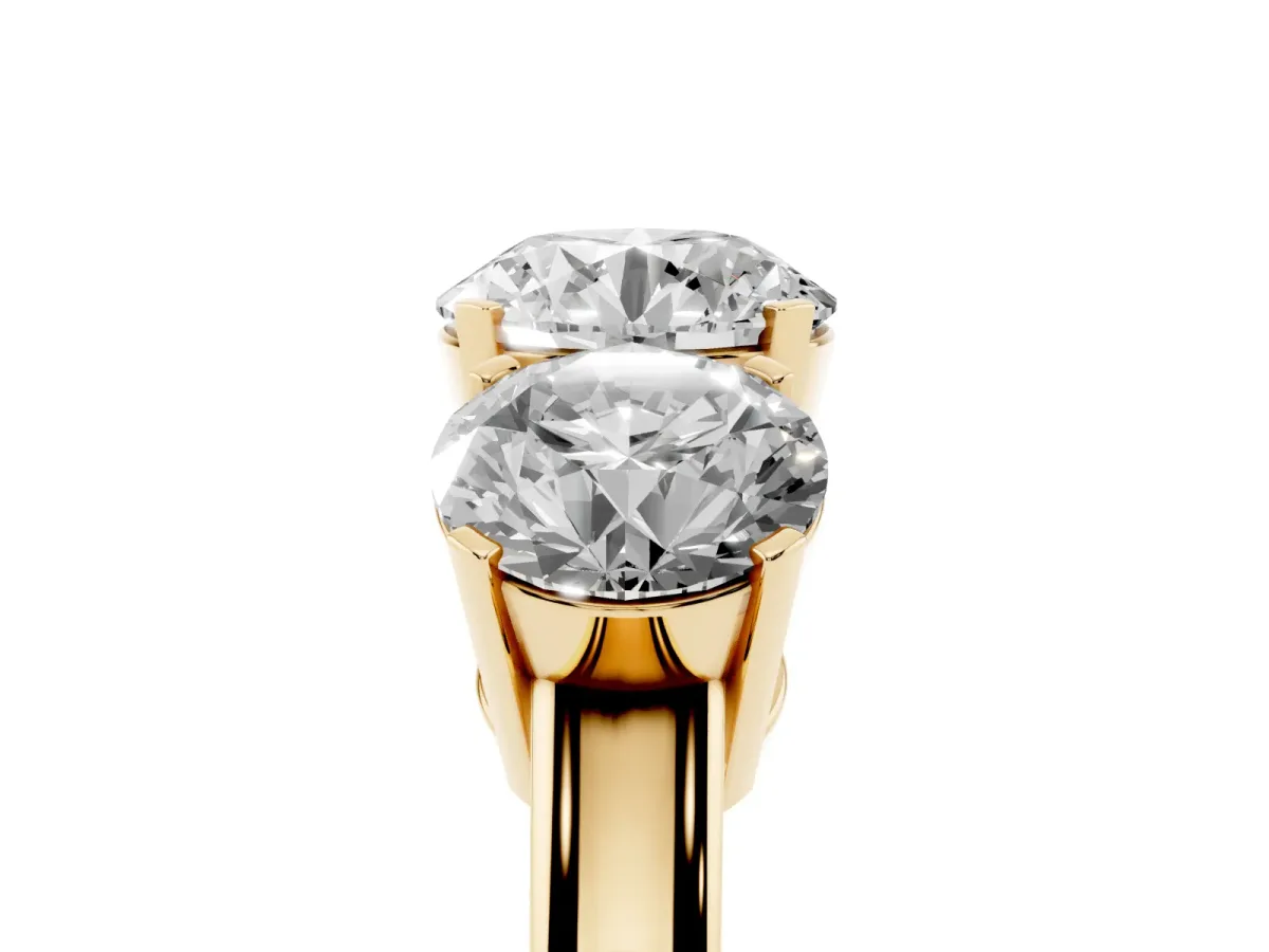Three-Stone Round Cut Cut Diamond Ring with Channel Set Band and Four-Prong Setting Yellow gold