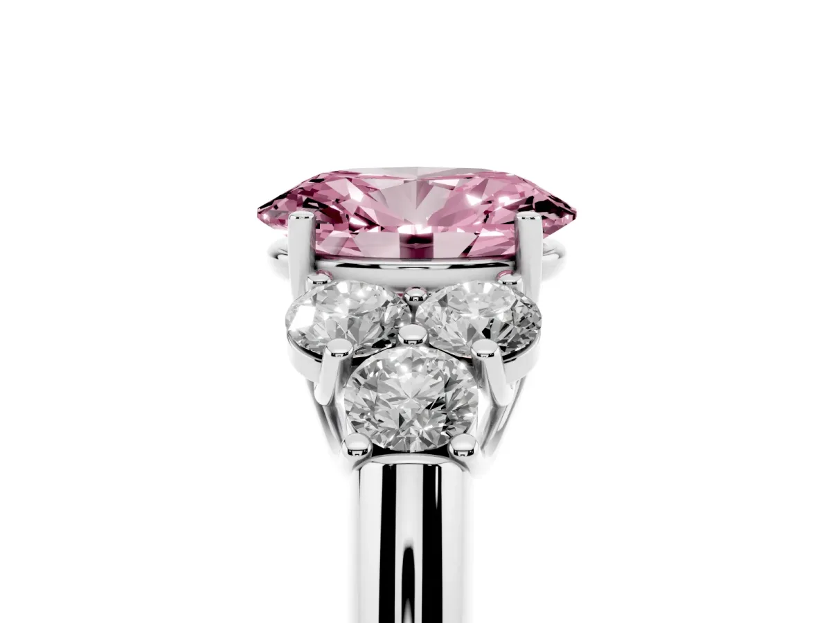 Fancy Pink Oval Cut Cut Diamond Cluster Ring with Round Accent Stones and Prong Setting on a Classic Band Platinum