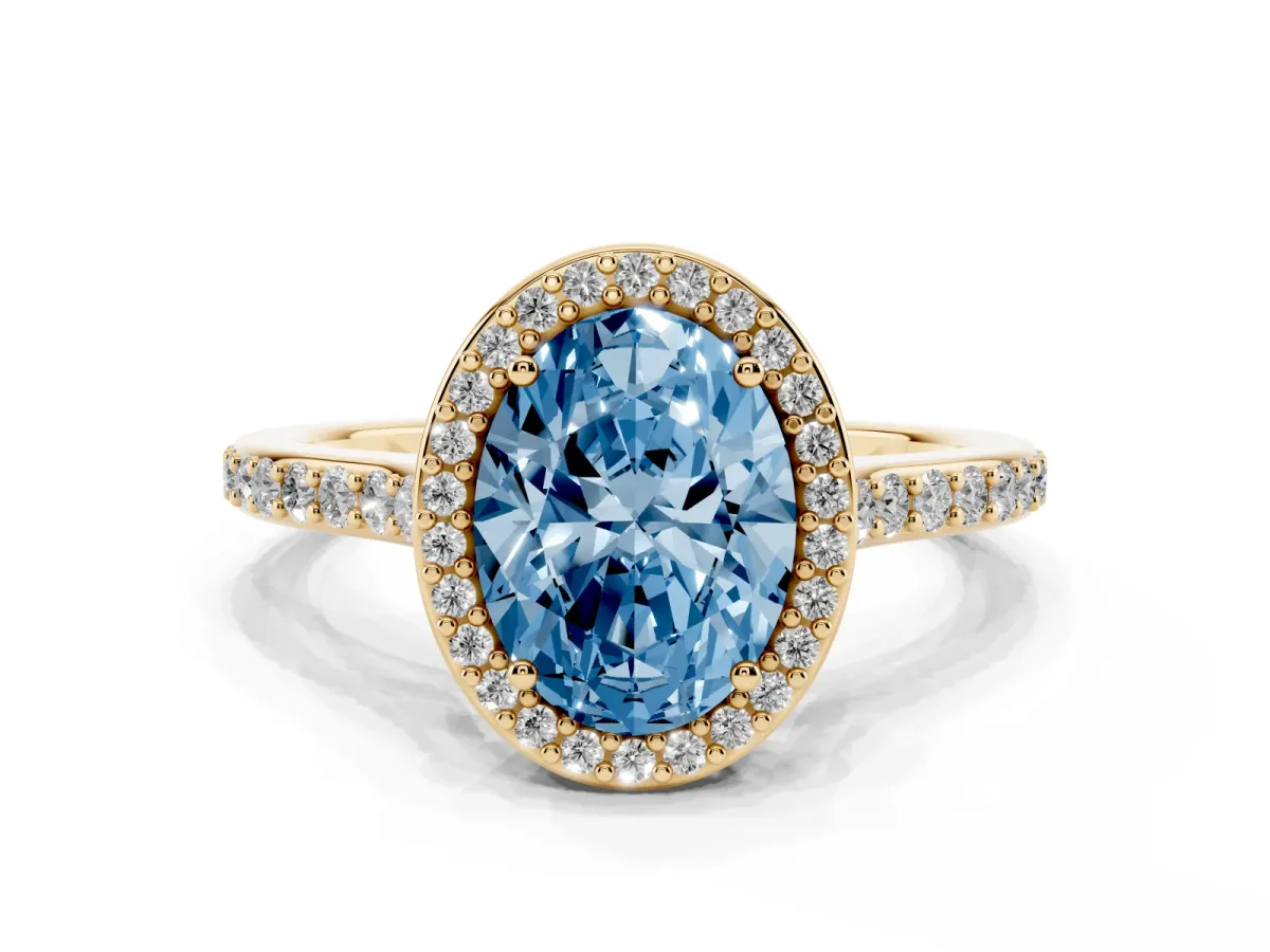 Fancy Blue Oval Cut Diamond Halo Engagement Ring with Round Pavé Shoulders and Prong Setting Yellow gold