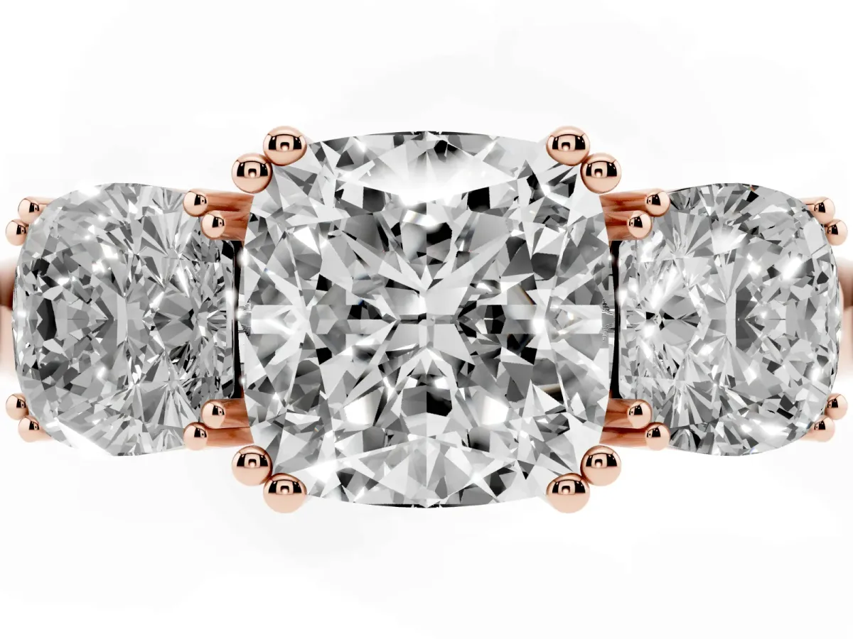 Three-Stone Cushion Cut Cut Diamond Ring with Channel Set Band and Four-Prong Setting Rose gold