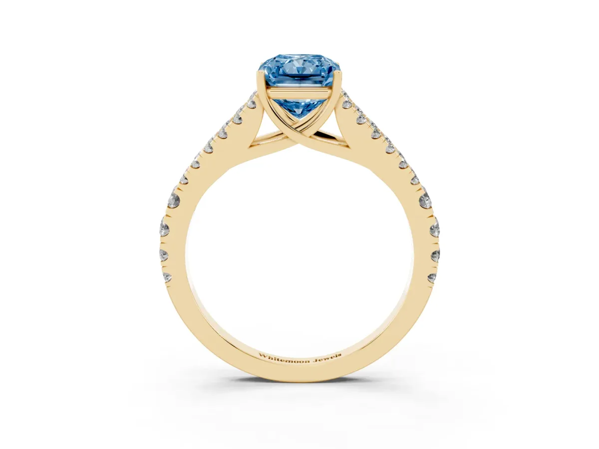 Fancy Blue Radiant Cut Diamond Split Shank Pavé Engagement Ring with Four-Prong Setting Yellow gold